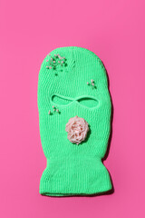 Green balaclava with flowers on pink background