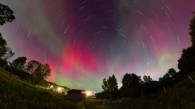 Amazing night sky bursting with Northern Lights and shooting stars. Shot with a 360 degree camera for ultra-wide view.