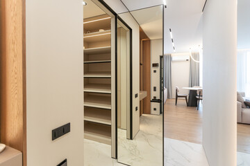 Modern interior, beautiful wardrobe without clothes. Empty wardrobe room with opened shelves. Walk in closet interior concept 