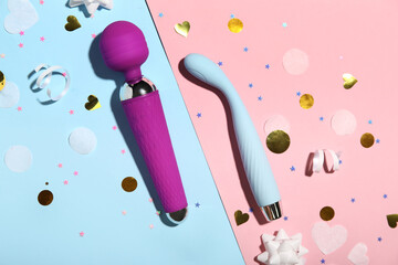 Composition with vibrators and confetti on color background