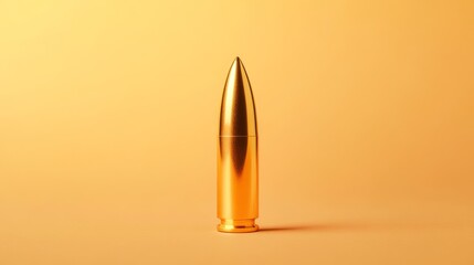 Obraz premium A solitary bullet with a shiny metallic surface is positioned vertically on a smooth pastel orange backdrop, creating a striking visual contrast and focus