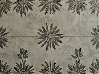 Grey floral design on white concrete.