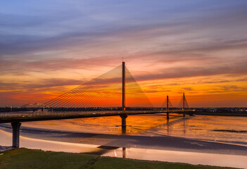 Liverpool, Merseyside, UK, September 18, 2024; aerial view of the Mersey Gateway toll bridge with stunning sun set over the River Mersey, Liverpool, UK.