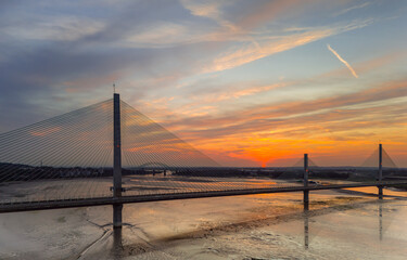 Liverpool, Merseyside, UK, September 18, 2024; aerial view of the Mersey Gateway toll bridge with stunning sun set over the River Mersey, Liverpool, UK.