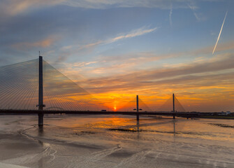 Obraz premium Liverpool, Merseyside, UK, September 18, 2024; aerial view of the Mersey Gateway toll bridge with stunning sun set over the River Mersey, Liverpool, UK.