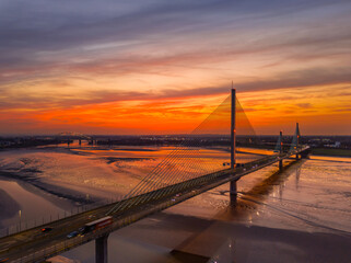 Liverpool, Merseyside, UK, September 18, 2024; aerial view of the Mersey Gateway toll bridge with stunning sun set over the River Mersey, Liverpool, UK.