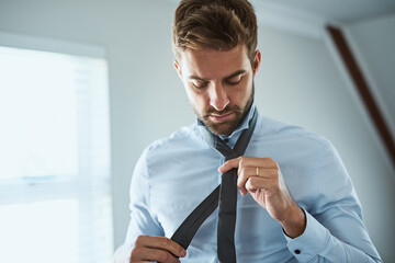 Dressing, man and tie in bedroom in house with getting ready and daily routine for new day in morning. Professional, person and changing outfit with preparation, hygiene and cleanliness in apartment