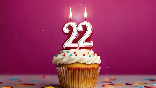 Birthday cupcake with burning lit candle with number 22. Number twentytwo for twentytwo years or twentysecond anniversary.