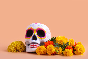 Painted human skull and beautiful marigold flowers on color background. El Dia de Muertos