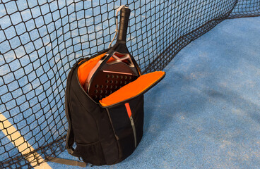  bag with tennis padel racket and ball on grassy field at tennis court, copy space. Unaltered,...