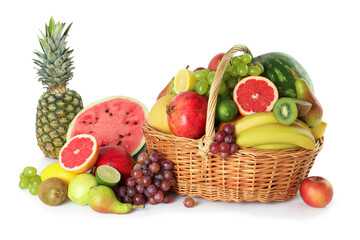 Many different fresh fruits in wicker basket isolated on white