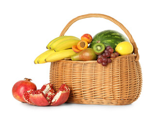 Many different fresh fruits in wicker basket isolated on white