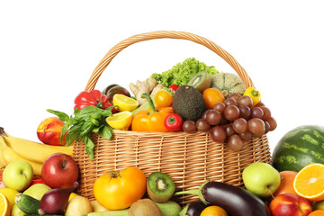 Many different fruits and vegetables in wicker basket isolated on white