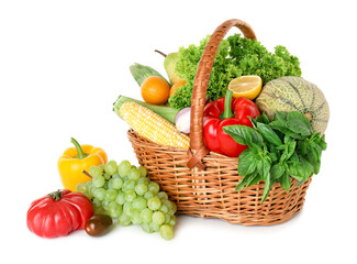 Different fresh fruits and vegetables in wicker basket isolated on white