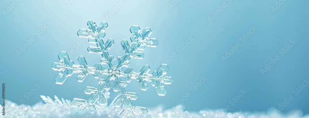 Poster close up of a delicate snowflake resting on soft white snow with a soothing blue background