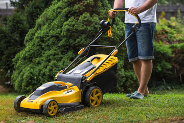 The banner. A lawn mower man mows the grass in the backyard. Agricultural machinery for garden maintenance.