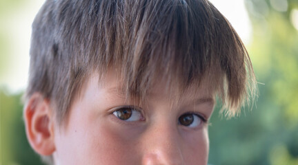 close-up part child's face, boy 10 years old Asian-European appearance, human eye looking...