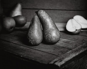 Pair of Conference pears on wooden fruit box black and white