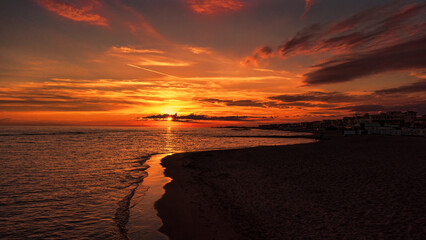 Wonderful golden sunset hour at the beach with skyline of Roman costaline