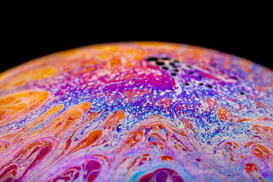 Iridescent thin film pattern inside a soap bubble, macro abstract texture background