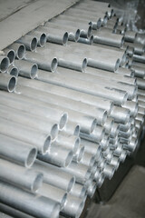 Obraz premium Metal steel pipe for construction materials, aluminium or stainless steel products on a factory or warehouse.