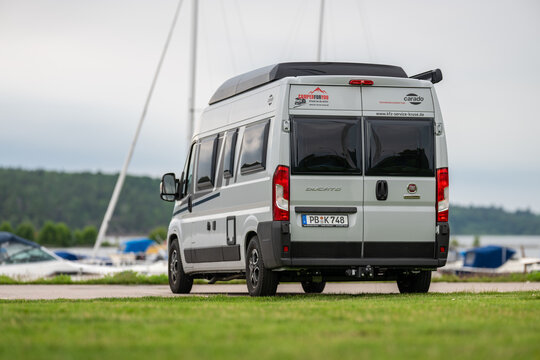 V?nersborg, Sweden - June 28 2024: Fiat Ducato recreational vehicle parked by a marina.