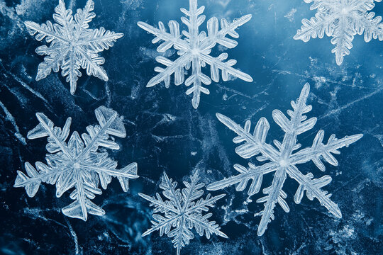White snowflakes on the surface of dark blue ice winter background