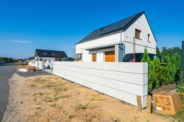Modern concrete blocks fence under construction