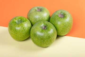 Vibrant Green Apples on Dual-Tone Background: Fresh Fruit Still Life, Healthy Snack, Organic Produce, and Color Contrast in Minimalist Food Photography