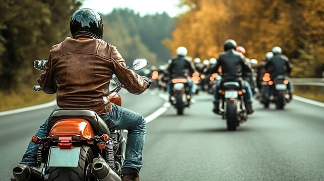 Biker riding on country road leading motorcycle group