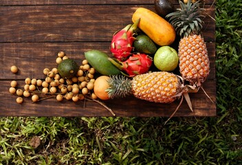 Fresh fruits and vegetables from Thailand and Bali beautifully arranged on a wooden table