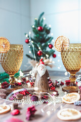 Christmas and New Year holidays background. Glasses of wine on wooden table with Christmas tree and decorations