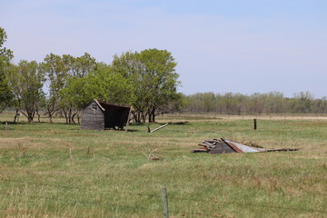 derelict abandoned farm shed partly disassembled