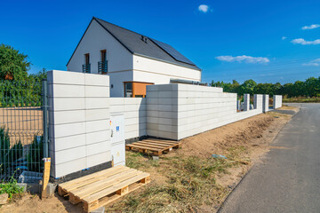 Completed concrete block fence with wires for sliding gate instalation