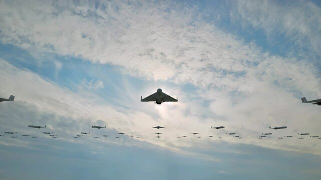 A swarm of fixed-wing unmanned aerial kamikaze drones flying toward their designated targets.