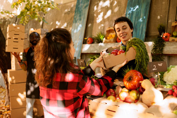 Young woman shopping at a farmers market, selecting fresh, organic produce from a local market...