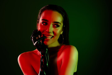 Photo of gorgeous model girl bite finger latex glove look empty space imagine neon lights background