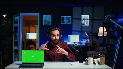 Entertainer presents chroma key laptop from brand sponsoring video, analyzing features. Content...