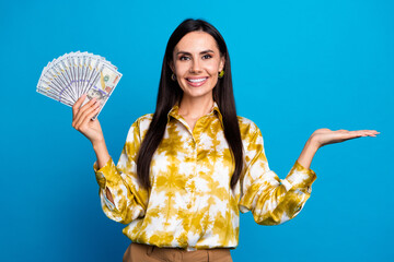 Photo of elegant successful brunette woman wear trendy blouse hold deposit budget empty space isolated on blue color background