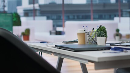 Empty corporate high end office prepared for job interviews and recruitment process, a computer displaying data and infographics. Business career development recruiting.