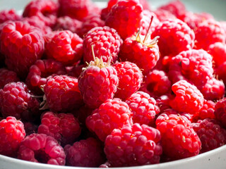 Close-up of fresh and ripe raspberries laying in a bowl. 