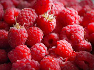 Close-up of fresh and ripe raspberries laying in a bowl. 