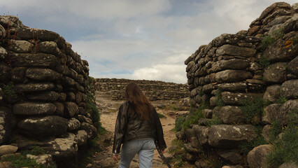 Exploring Stone Passage at Castro de Baroña