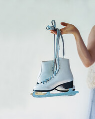 Classic leather white figure skates Elegant dressed up woman wearing the gray dress and faux fur...
