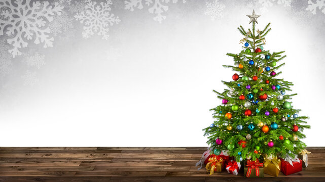 Festive bright Christmas scene with an elegant decorated fir tree and white wall background as copy space framed with gray snowflake design