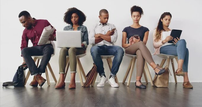 Business, people and waiting room for interview, line and ready for recruitment opportunity for career. Men, women and sitting on chair for job, hiring process or application at human resource agency