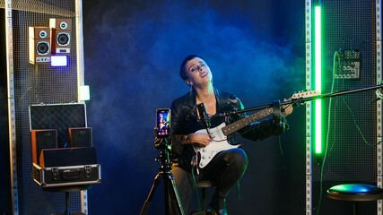 Social media artist live streaming a song for her music vlog, live event vocal performance online...