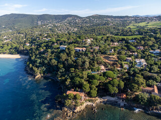 Aerial view on boats, crystal clear blue water of Plage du Debarquement white sandy beach near Cavalaire-sur-Mer and La Croix-Valmer, summer vacation on French Riviera, Var, France