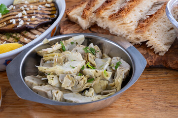 Italian food, pickled grilled artichokes hearts in olive oil close up