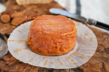 Rond des Vignes washed-rind cheese with.ivory-orange rind, strong nose with aromas, French soft cheese with orange rind